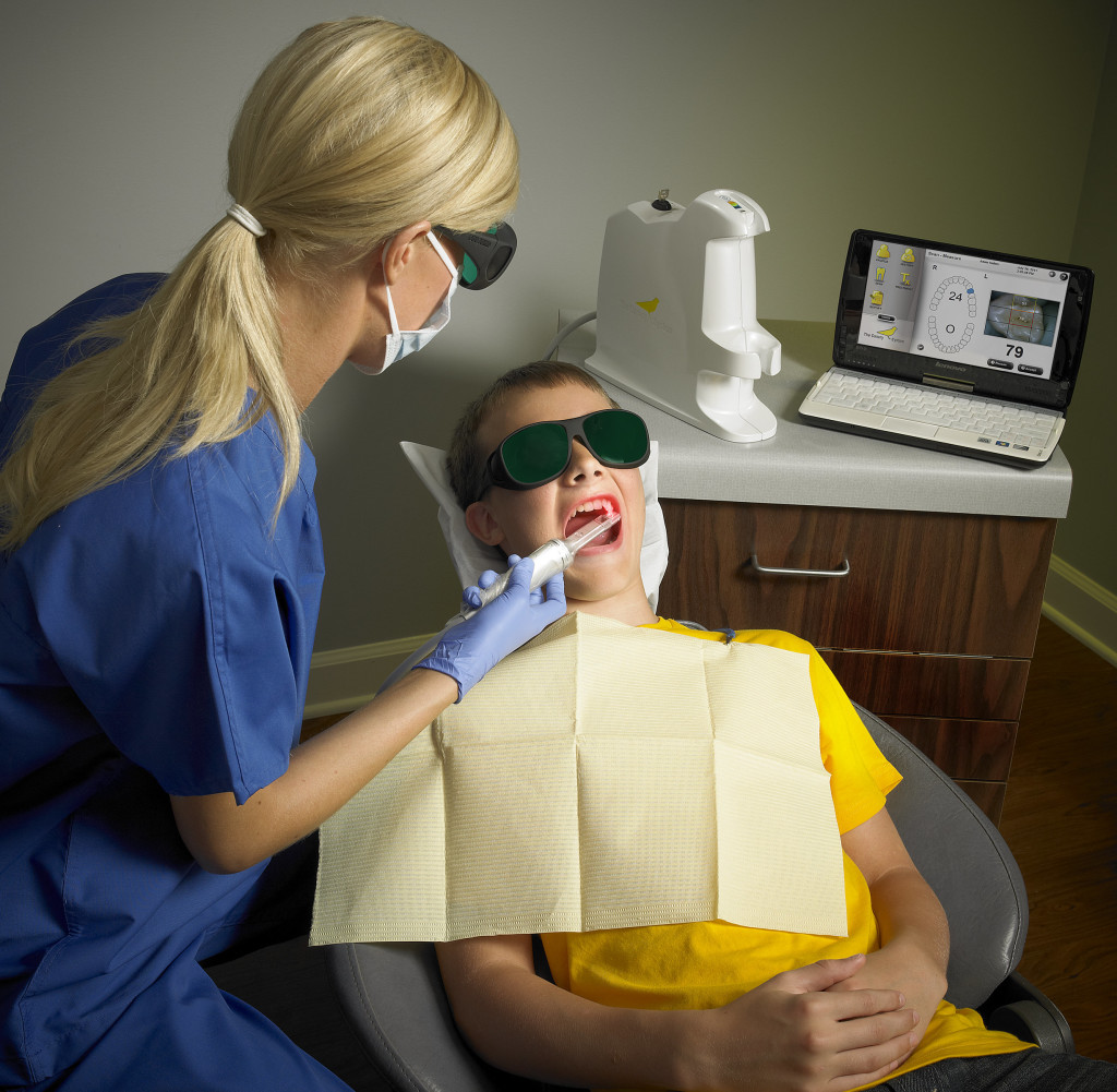 Hygienist Using Canary Cloud Early Tooth Decay Detection - Dr. Bolding Omaha Cosmetic Dentist
